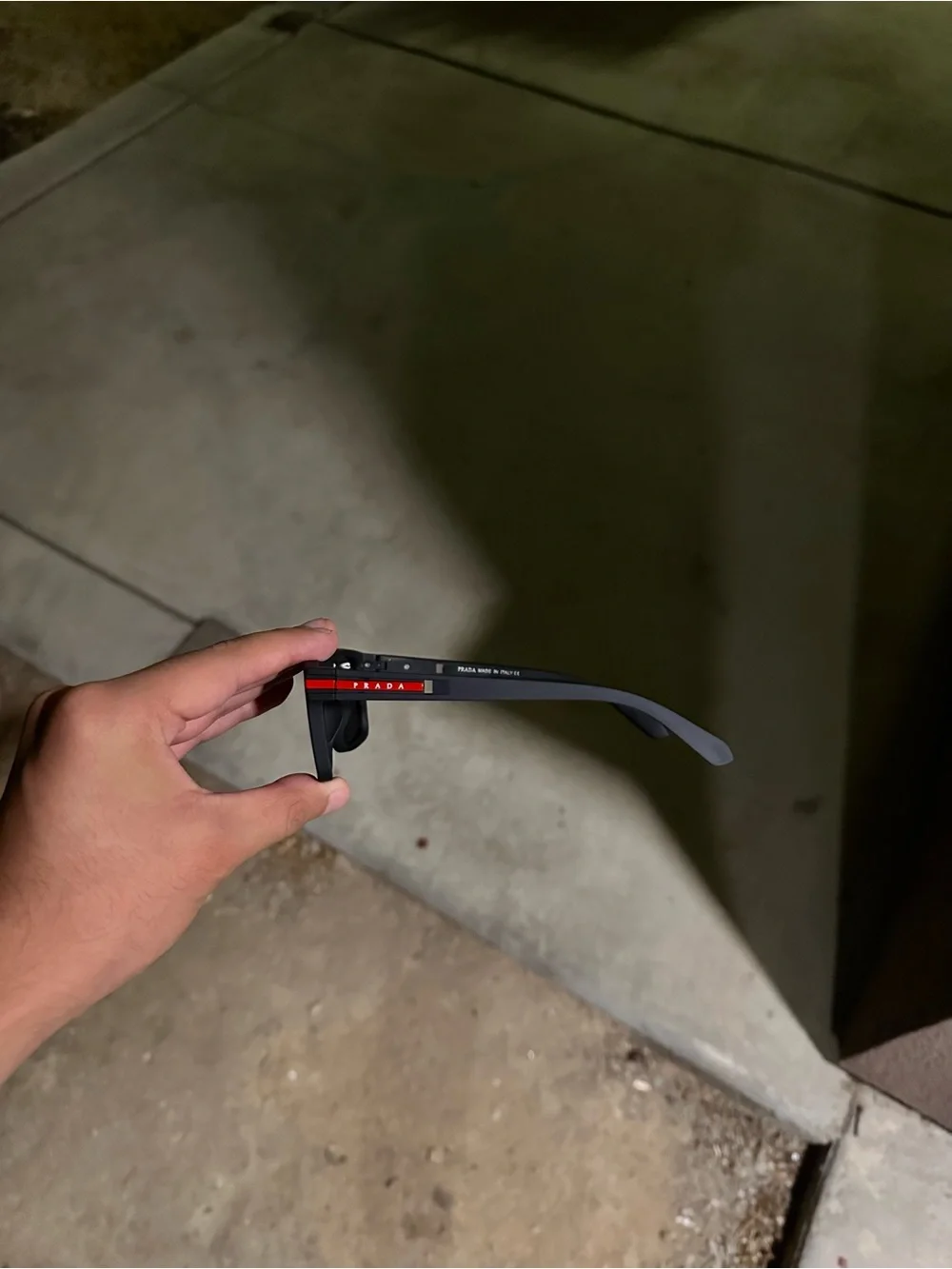 Prada Men’s Black Sunglasses with Red Temple Detail